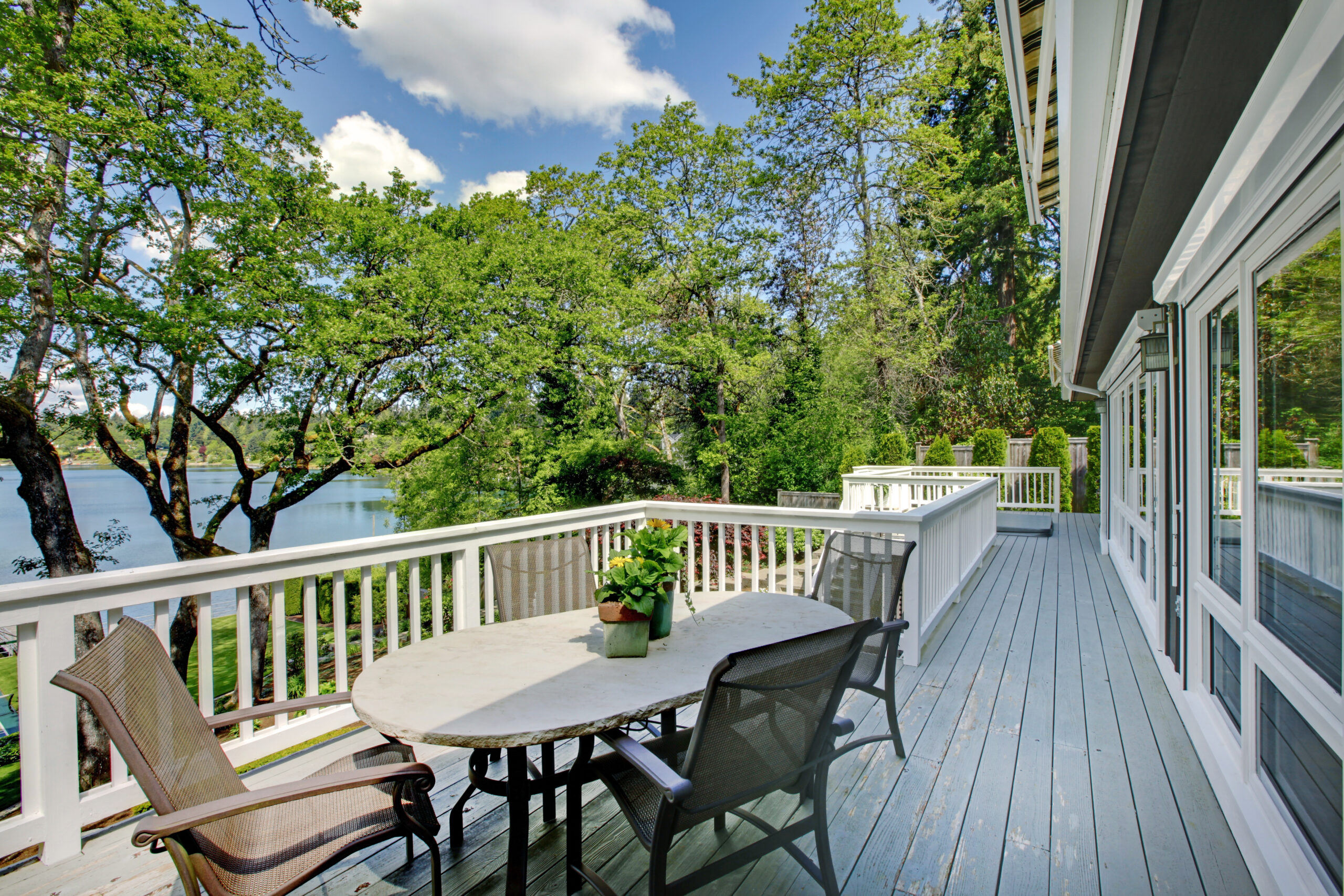 Large long balcony home exterior with table
